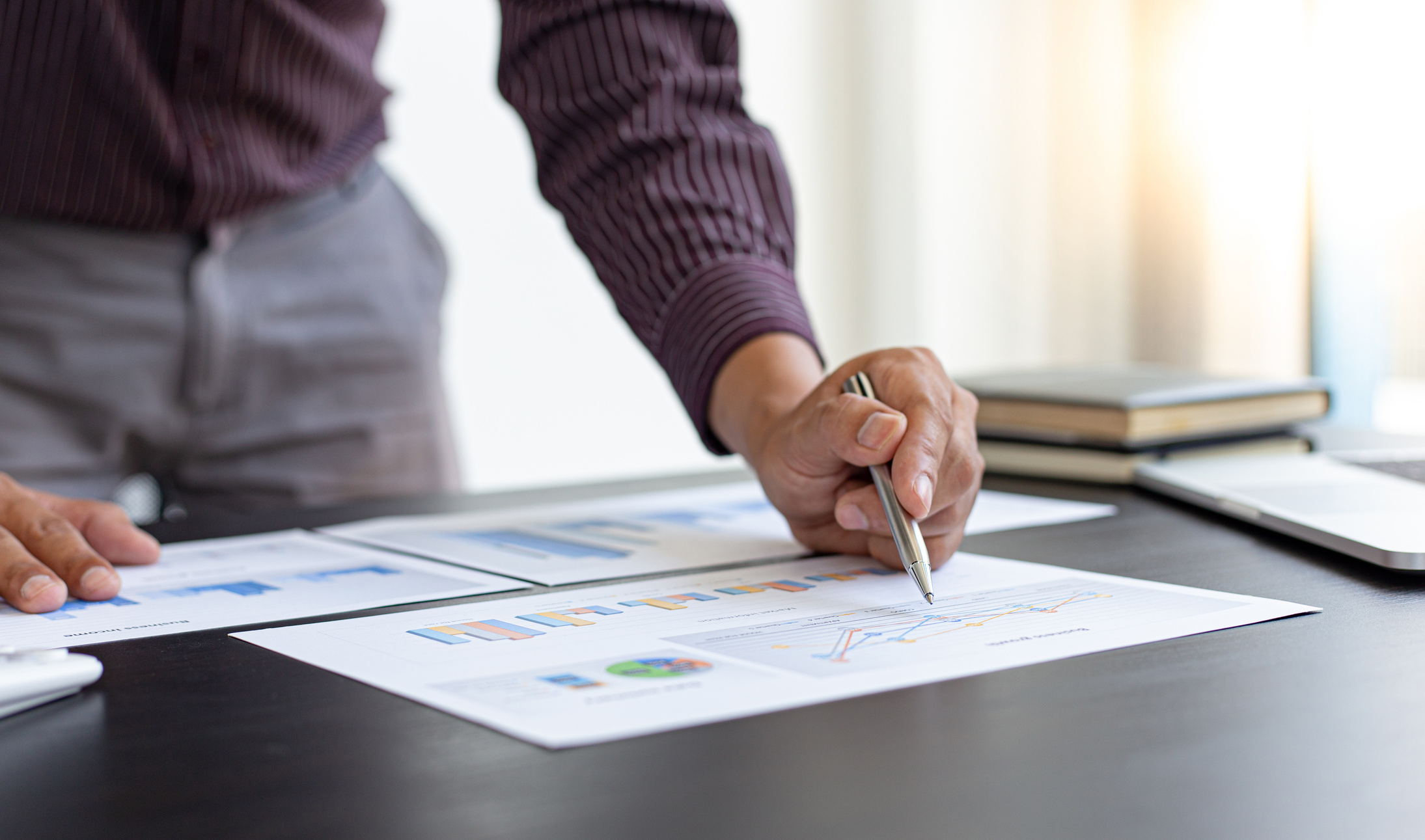 Person Analyzing Reports in an Office