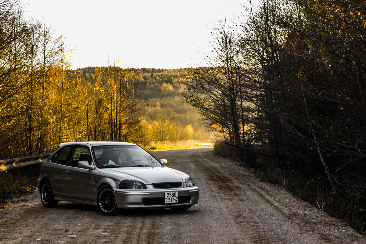Photo of a Gray Car on a Dirt Road
